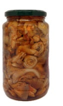 Tris di Funghi in Olio di semi di Girasole in a glass jar, showcasing various mixed mushrooms.