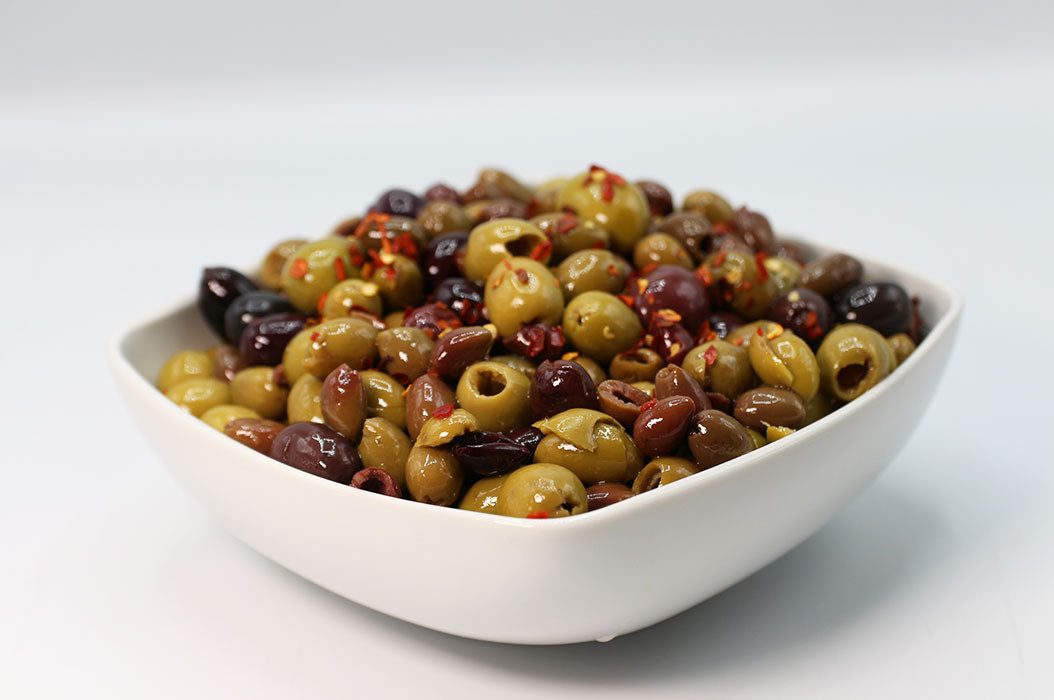 Cocktail di Olive alla Calabrese in a bowl containing green and black olives with chili flakes.