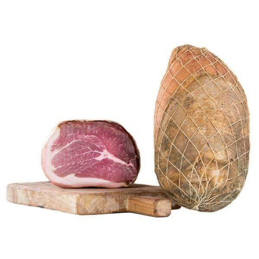 Culatta Emiliana di Modena intera 5 kg. c.a. on a wooden board with prosciutto slice and whole salume.
