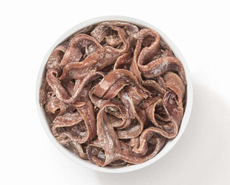 Filetti di Alici del Cantabrico in a bowl, hand-prepared and preserved in olive oil, perfect for appetizers.