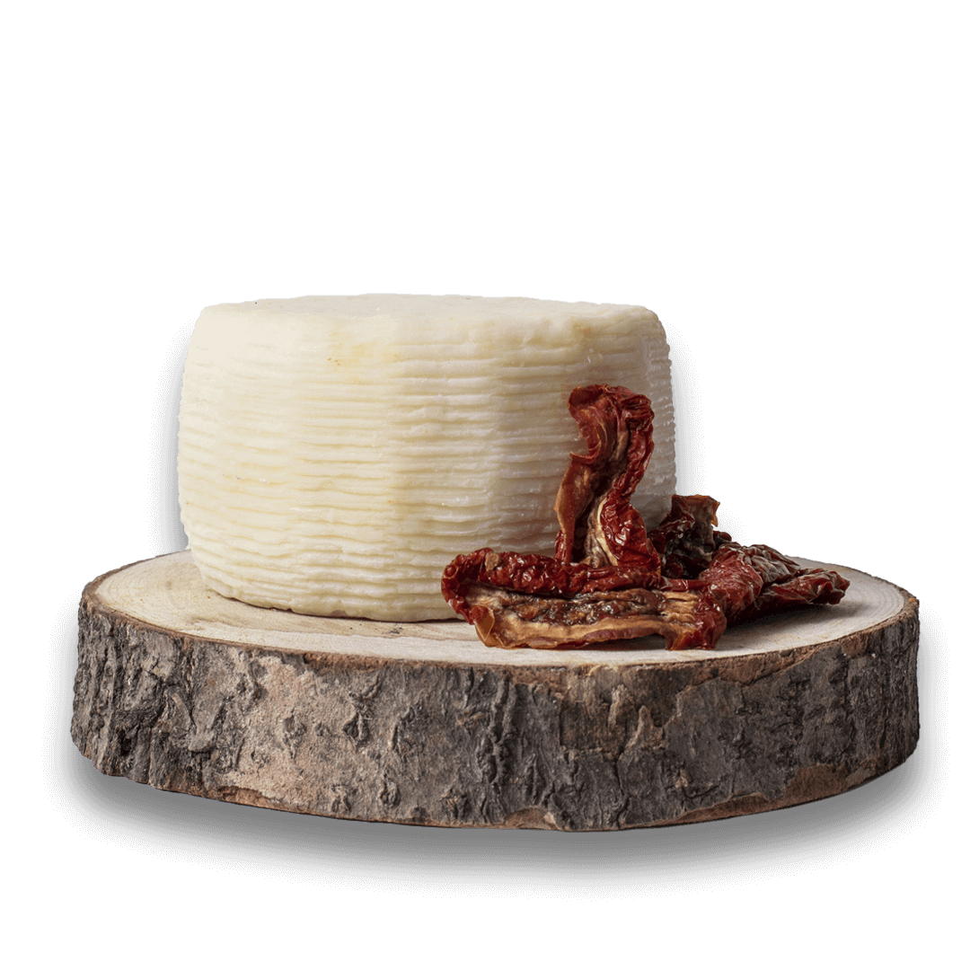 Formaggio di Capra on a wooden board with dried herbs, highlighting the artisanal quality of Formaggio di Capra.