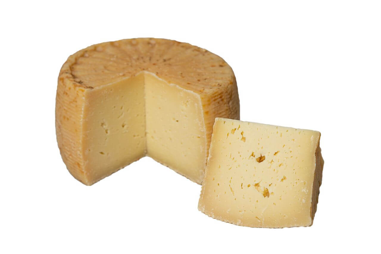 Wheel of Ulisse sheep milk cheese with slice, aged in olive oil, 6 kg, semi-hard texture, traditional Calabrian and Sicilian cheese