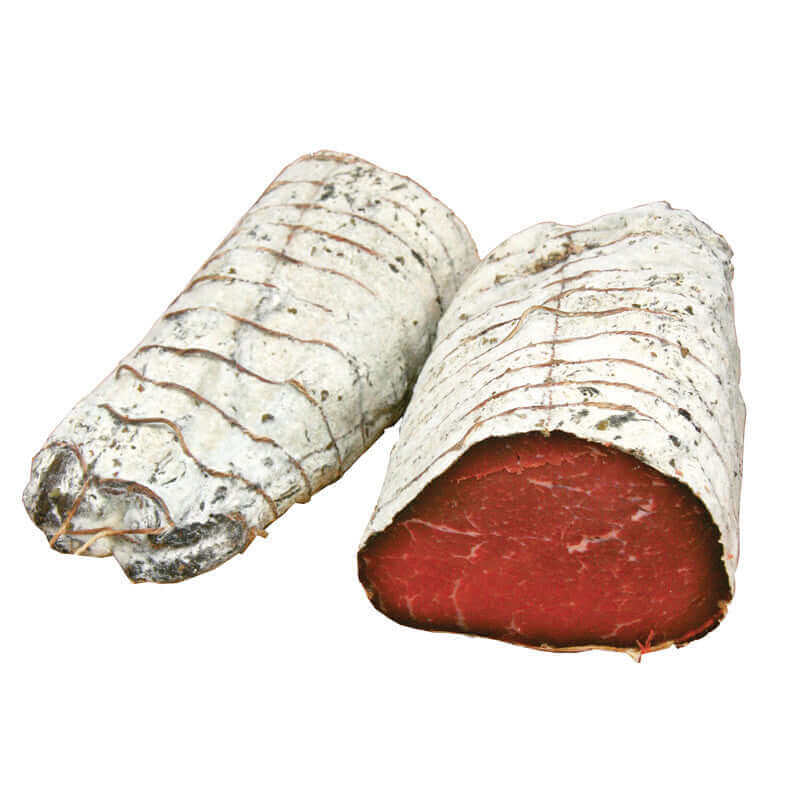 Two pieces of bresaola, one cut to show the rich, dark red cured meat inside, wrapped in protective white casing.