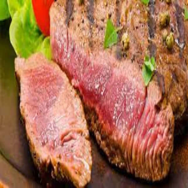 Delicious Cuberoll di Scottona cooked to perfection, showcasing tender slices with garnish and fresh vegetables.