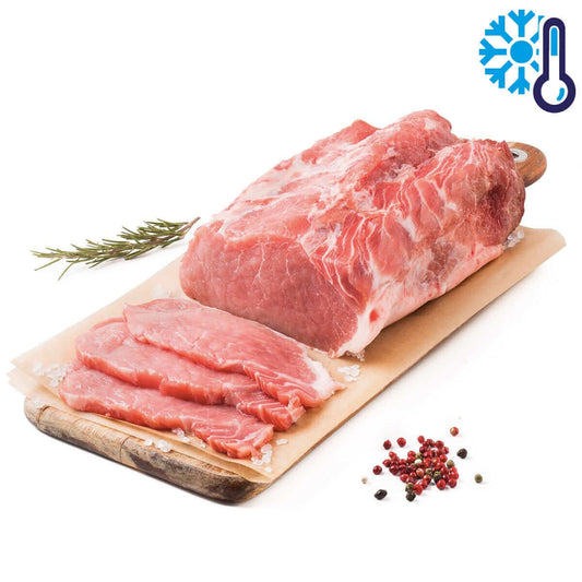 Filetto di Maiale Semibrado Calabrese on a wooden board with herbs and spices.