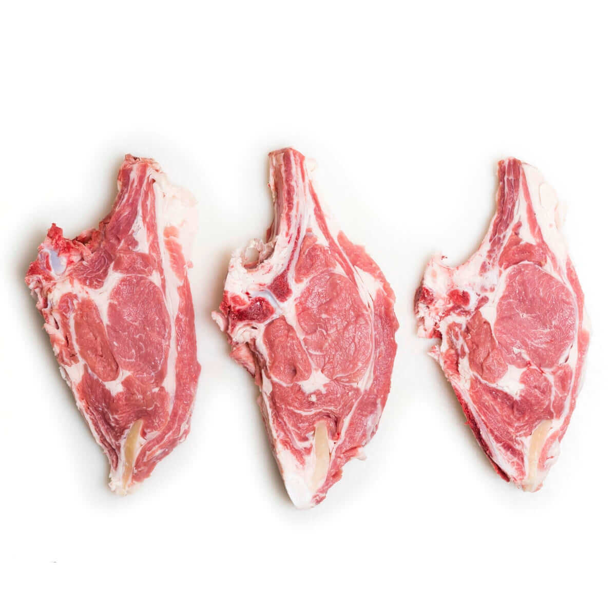 Lombata di Vitello Podolico - Fresh veal chops displayed on a white background.