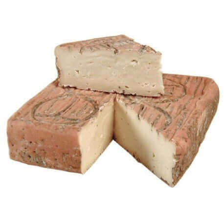 Taleggio DOP cheese, creamy and washed rind, cut pieces showcasing Italian origin and flavor.