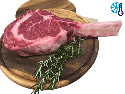 Raw tomahawk steak with rosemary on a wooden cutting board, indicating fresh and premium quality meat.