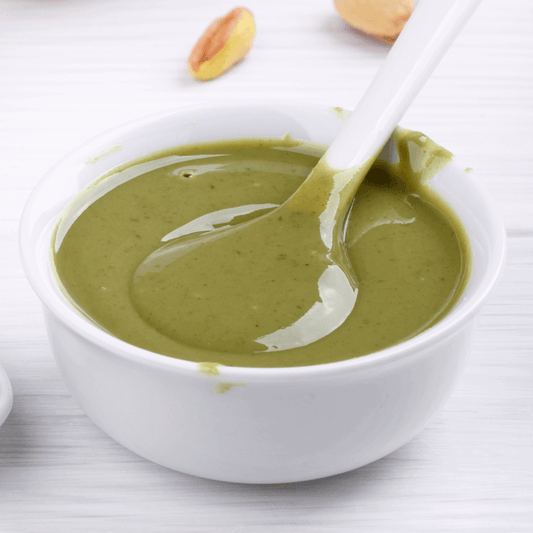 Pure Mediterranean Pistachio Paste in white bowl for gelateria and pasticceria. No colorants or artificial flavors.